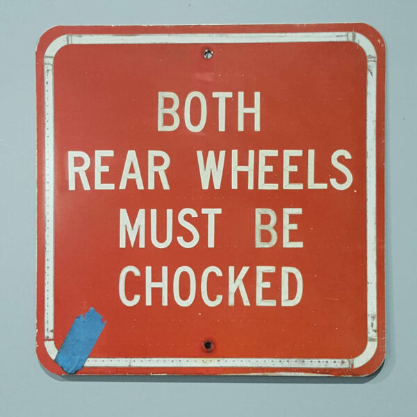 American Both Rear Wheels Must Be Chocked Sign