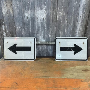 Two Black Arrow Signs on Pole